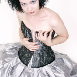 pierced tattooed hottie in silver skirt and corset
