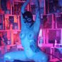 naked tattooed dominatrix in high boots with whip