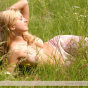 Young nice Marina with perfect breast poses naked in the field.
