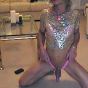 Tranny Kim wearing a golden sparkly top and playing with her asshole