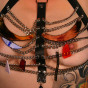 tattooed busty milf in chain and leather harness