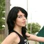 Young teen tugs at her short skirt